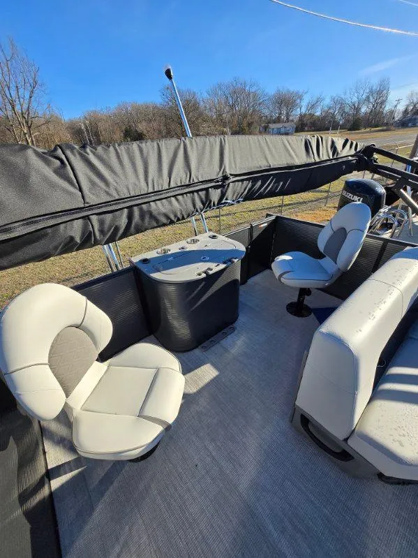 Slide: The Image of 2025 Qwest E-CLASS 22 XRE CRUISE boat interior with seating and table. - 6