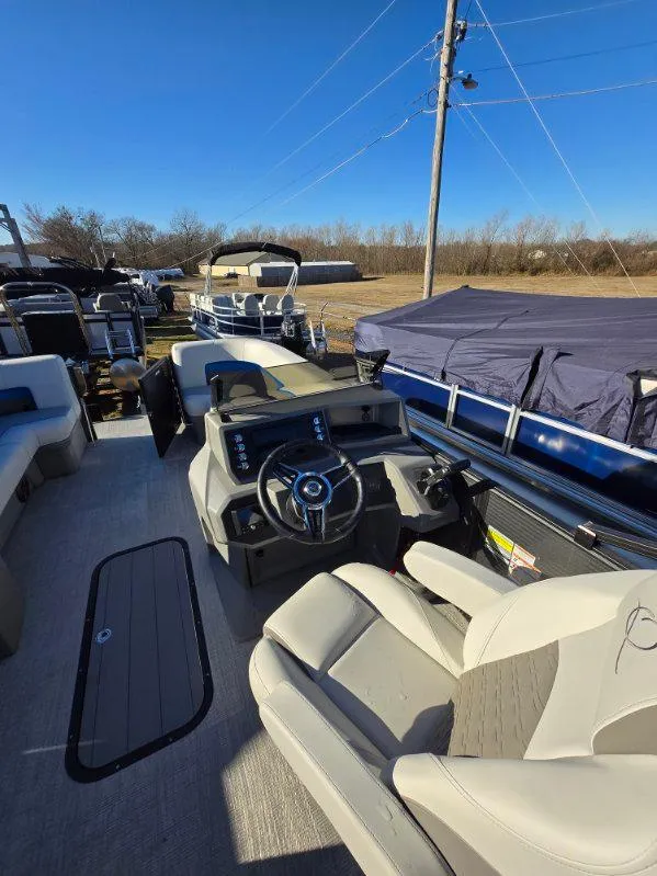 Slide: The Image of 2025 Qwest E-CLASS 22 XRE CRUISE boat interior with steering wheel and seating. - 8