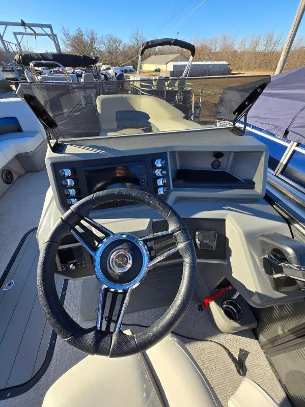 Slide: The Image of 2025 Qwest E-CLASS 22 XRE CRUISE boat dashboard with steering wheel and control panel. - 9