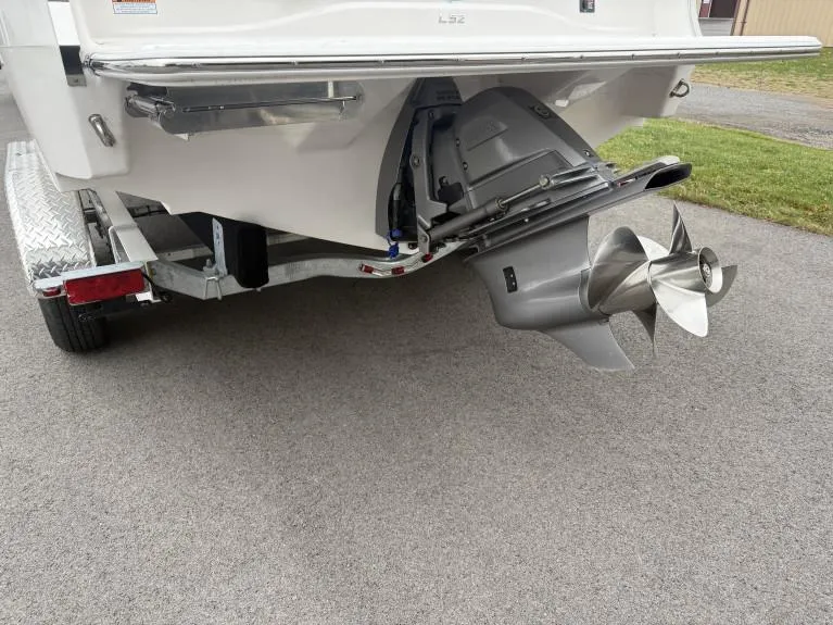 Slide: The Image of 2023 Regal LS2 boat on trailer, showing propeller and stern drive. - 2