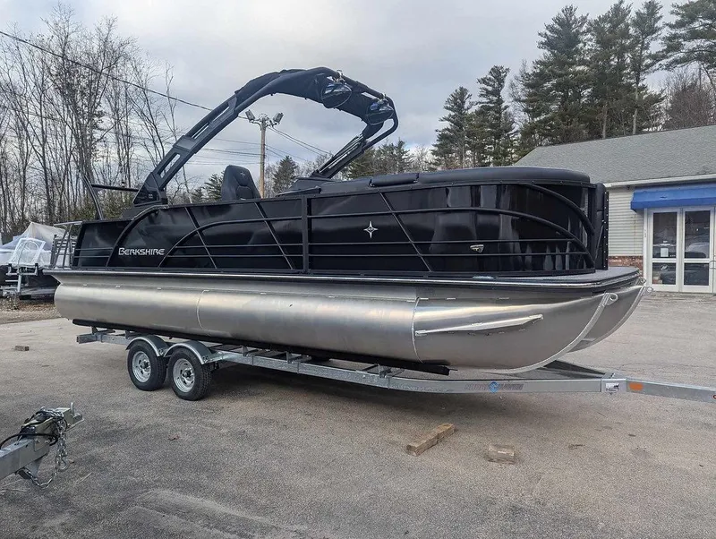 Slide: The Image of 2025 Berkshire 23ULE pontoon boat on trailer, parked outdoors. - 10