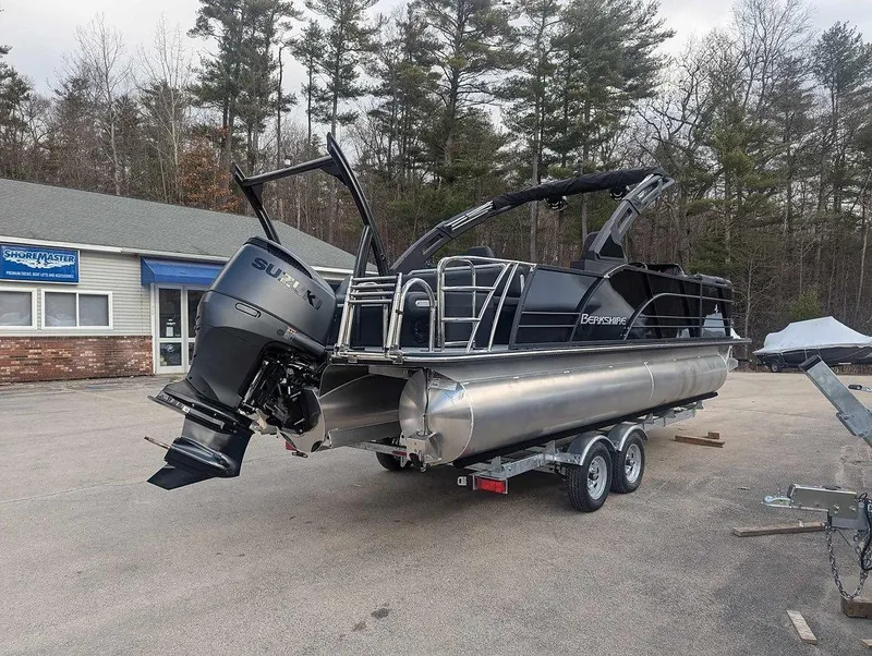 Slide: The Image of 2025 Berkshire 23ULE pontoon boat with Suzuki outboard motor on trailer. - 11