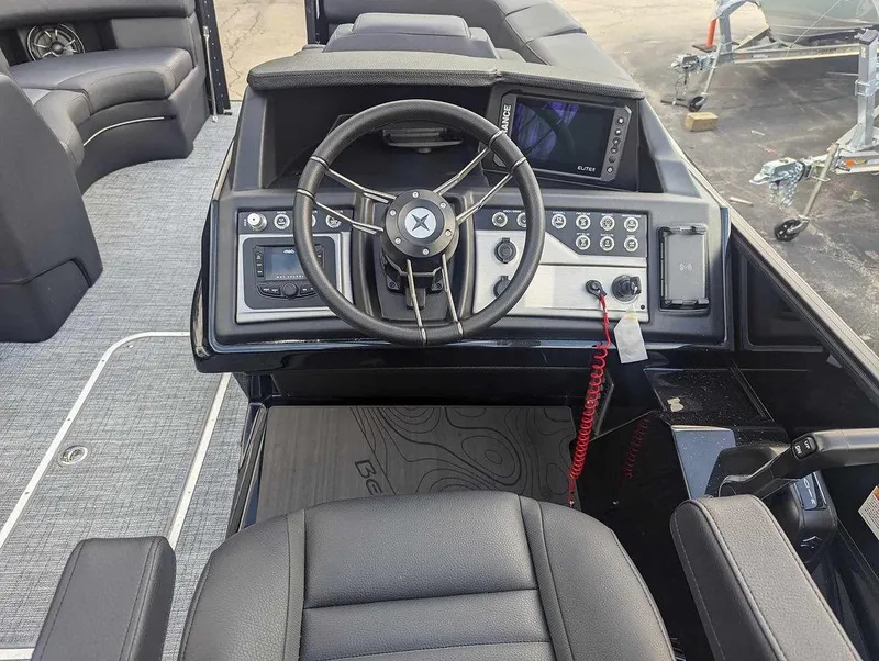Slide: The Image of 2025 Berkshire 23ULE boat dashboard with steering wheel and control panel. - 7