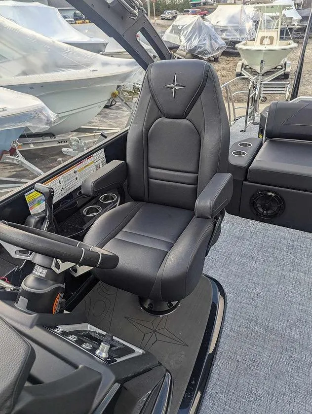Slide: The Image of 2025 Berkshire 23ULE boat interior with black captain's chair and control panel. - 8