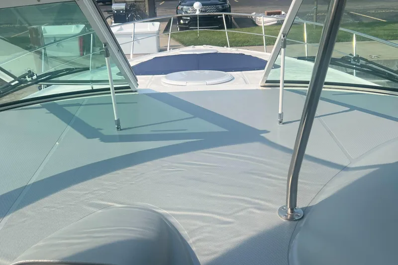 Slide: The Image of 2006 Cruisers Yachts 420 Express deck view with windshield and seating area. - 13