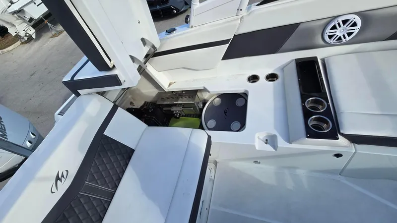 Slide: The Image of 2023 Monterey M225 boat interior with seating and cup holders. - 6