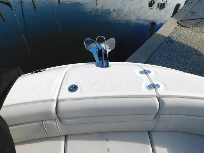 Slide: The Image of 2020 Sea Ray SDX 270 Outboard boat with white seating and anchor at dock. - 11