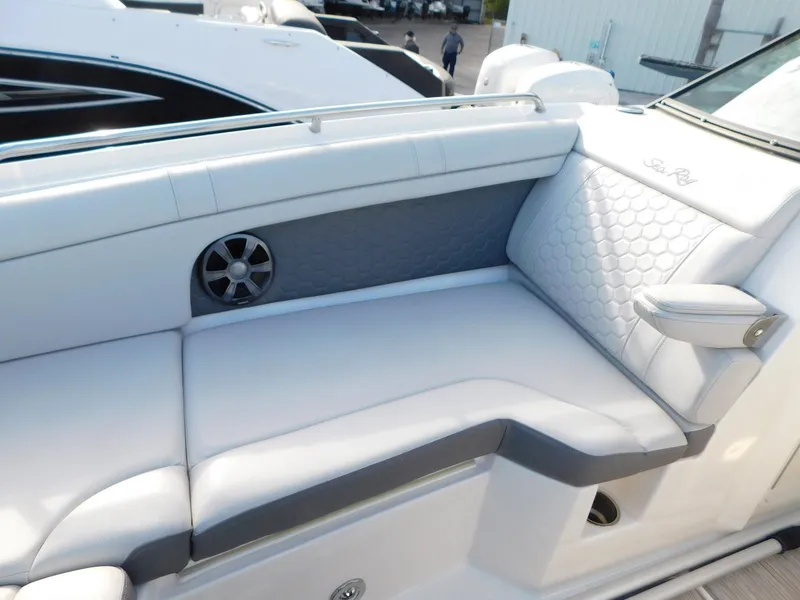 Slide: The Image of 2020 Sea Ray SDX 270 Outboard boat interior with white cushioned seating. - 12