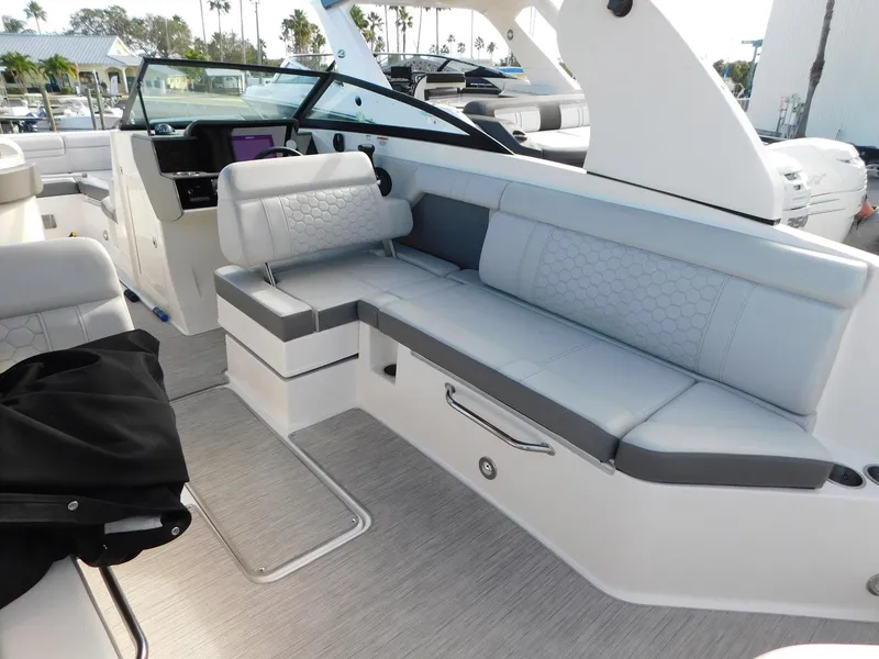 Slide: The Image of 2020 Sea Ray SDX 270 Outboard interior with white seating and modern design. - 14
