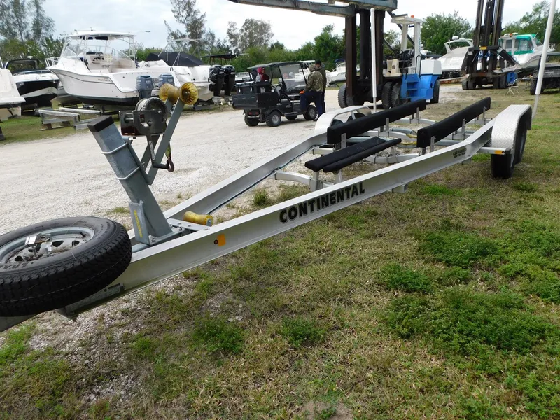 Slide: The Image of Continental boat trailer for 2020 Sea Ray SDX 270 Outboard, parked on grassy area. - 21