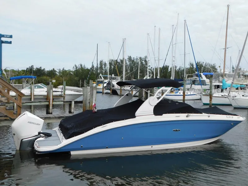 Slide: The Image of 2020 Sea Ray SDX 270 Outboard boat docked in marina, covered and ready for use. - 22