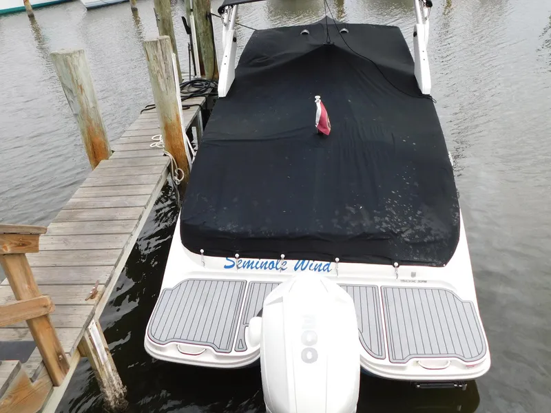 Slide: The Image of 2020 Sea Ray SDX 270 Outboard boat docked with cover, rear view. - 23