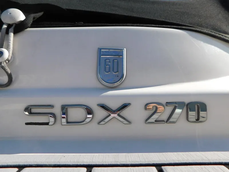 Slide: The Image of 2020 Sea Ray SDX 270 Outboard boat emblem and model badge. - 3