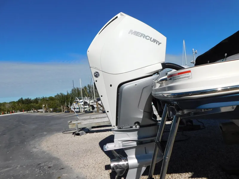 Slide: The Image of 2020 Sea Ray SDX 270 Outboard with Mercury engine, parked on gravel near water. - 4