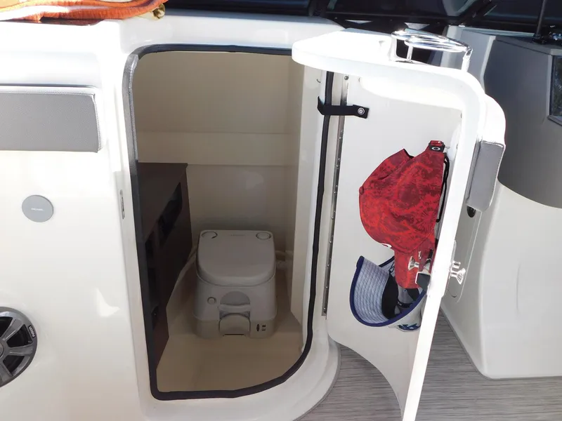 Slide: The Image of 2020 Sea Ray SDX 270 Outboard boat interior with compact marine toilet. - 8