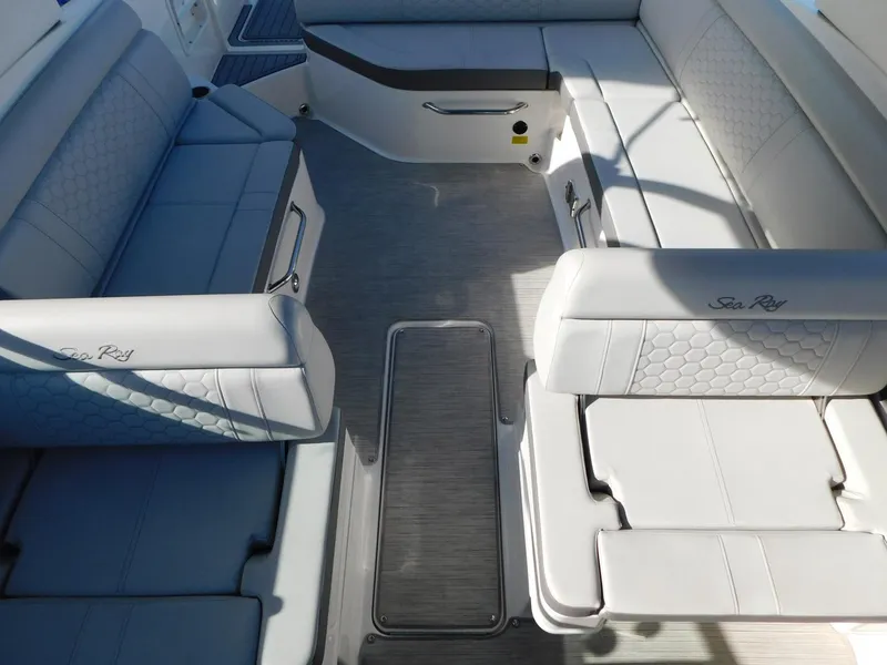 Slide: The Image of 2020 Sea Ray SDX 270 Outboard interior with white seating and spacious layout. - 9