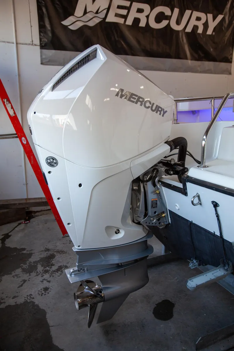 Slide: The Image of Mercury outboard motor on a 2000 Boston Whaler 210 Outrage boat in a garage. - 11