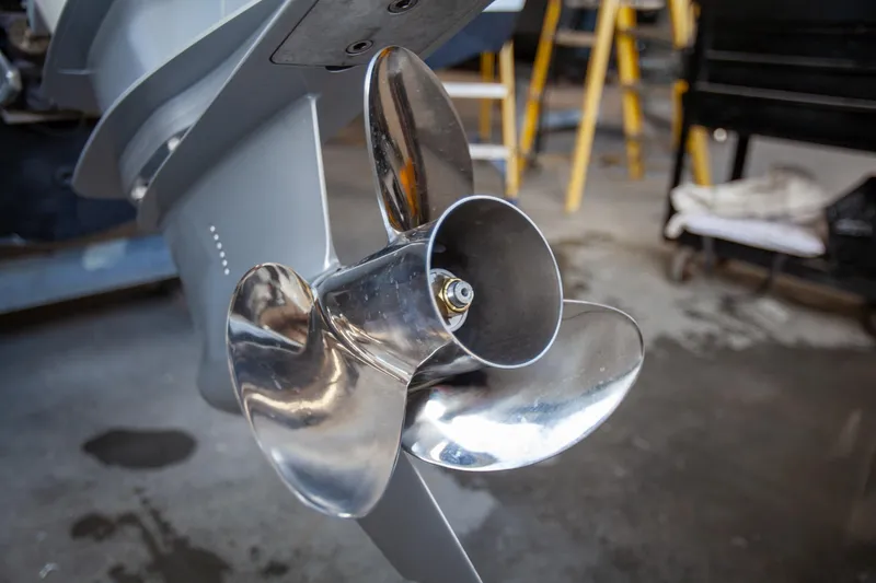 Slide: The Image of Close-up of a Boston Whaler 210 Outrage 2000 boat propeller in a workshop. - 15