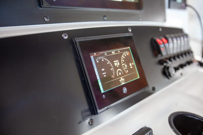 Slide: The Image of Dashboard of a 2000 Boston Whaler 210 Outrage boat with digital display and controls. - 19