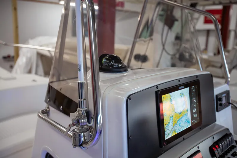 Slide: The Image of Boston Whaler 210 Outrage 2000 model with navigation system and controls in a boat interior. - 21