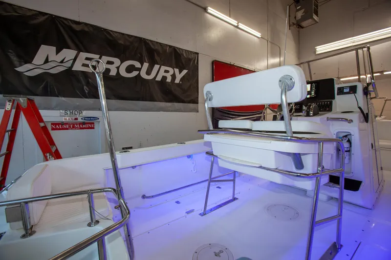 Slide: The Image of Boston Whaler 210 Outrage 2000 model interior with Mercury banner in a showroom. - 3