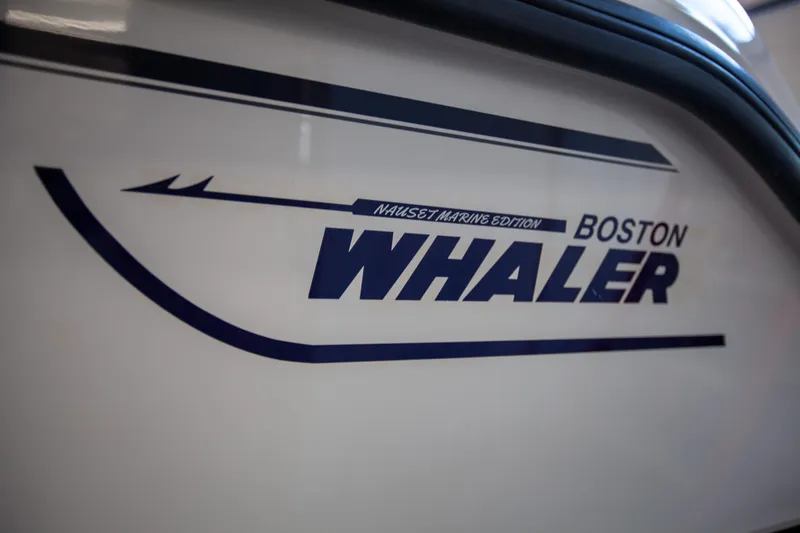 Slide: The Image of Boston Whaler 210 Outrage 2000 logo on boat hull, close-up view. - 9