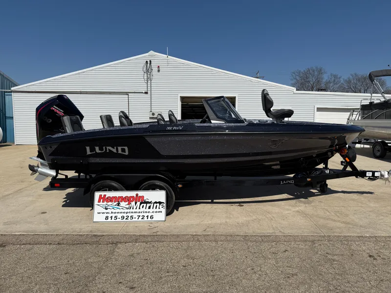 The Image of 2025 Lund 202 Pro-V GL boat on trailer outside Hennepin Marine dealership. - 0
