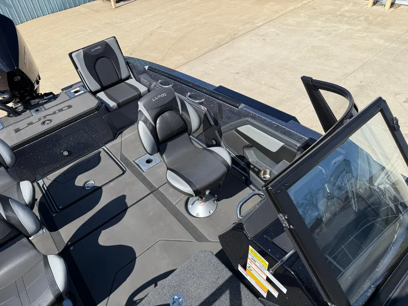 Slide: The Image of 2025 Lund 202 Pro-V GL boat interior with seating and control panel. - 20
