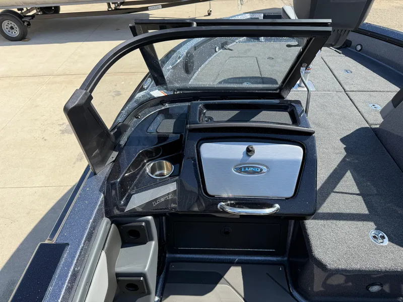 Slide: The Image of 2025 Lund 202 Pro-V GL boat interior with storage compartment and seating. - 22