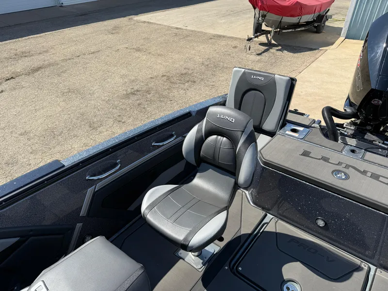 Slide: The Image of 2025 Lund 202 Pro-V GL boat interior with comfortable seating and sleek design. - 24