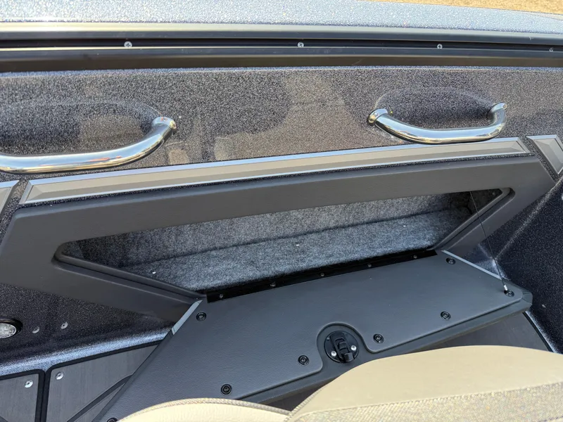 Slide: The Image of 2025 Lund 202 Pro-V GL boat interior storage compartment with sleek handles and modern design. - 25