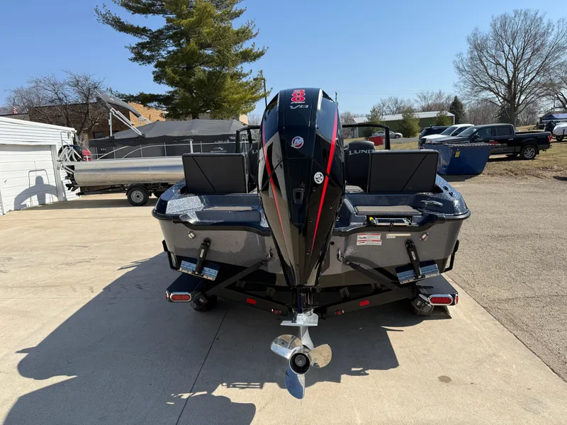Slide: The Image of 2025 Lund 202 Pro-V GL boat, rear view, parked outdoors on a sunny day. - 3