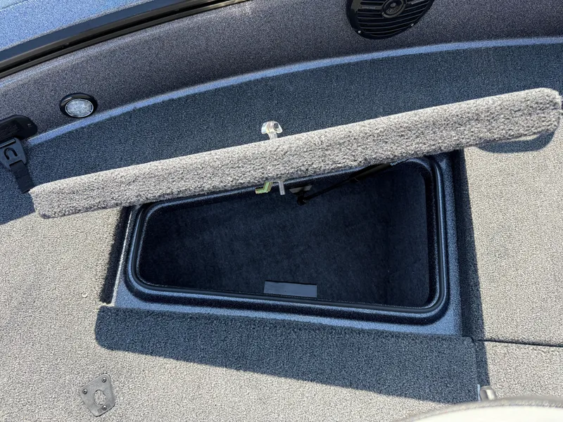 Slide: The Image of 2025 Lund 202 Pro-V GL boat storage compartment with open lid, showcasing interior space. - 6