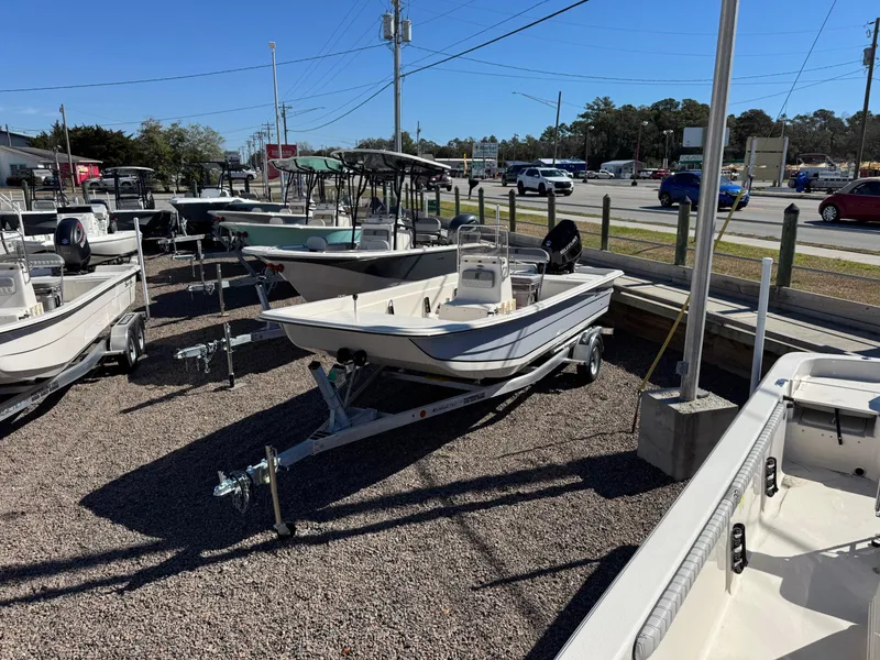 The Image of 2025 Carolina Skiff E21 DLX CC boat displayed in outdoor dealership lot. - 0