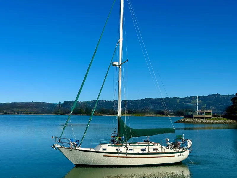 Slide: The Image of 1998 Pacific Seacraft Cutter sailboat on calm water under clear blue sky. - 0