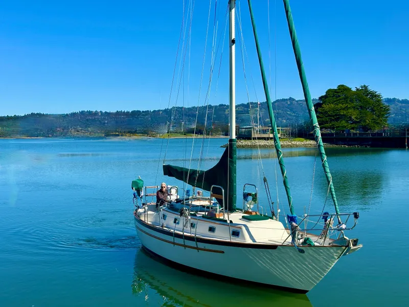 Slide: The Image of 1998 Pacific Seacraft Cutter sailboat on serene water with clear blue sky. - 1