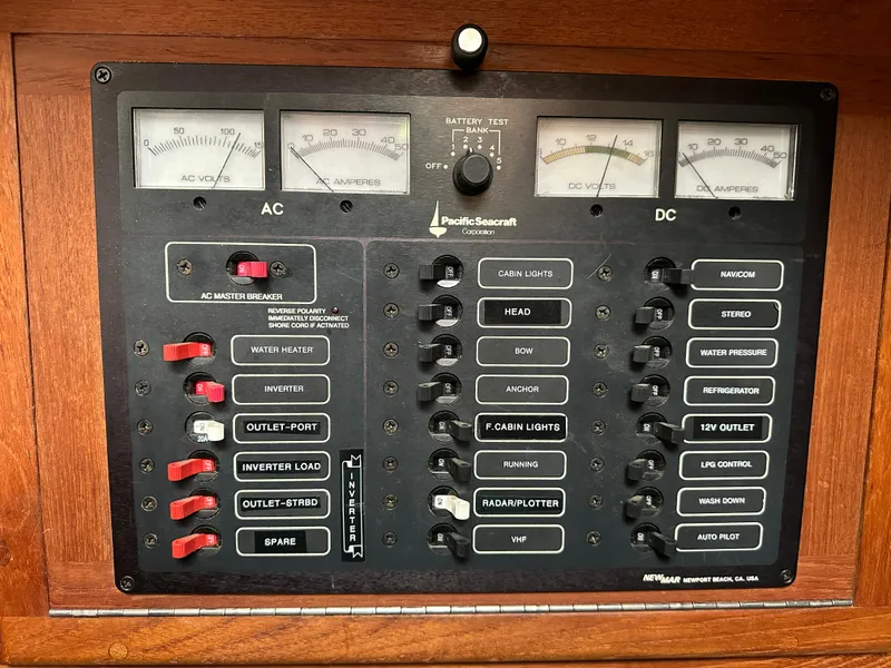 Slide: The Image of Electrical panel of a 1998 Pacific Seacraft Cutter sailboat, featuring AC and DC controls. - 16