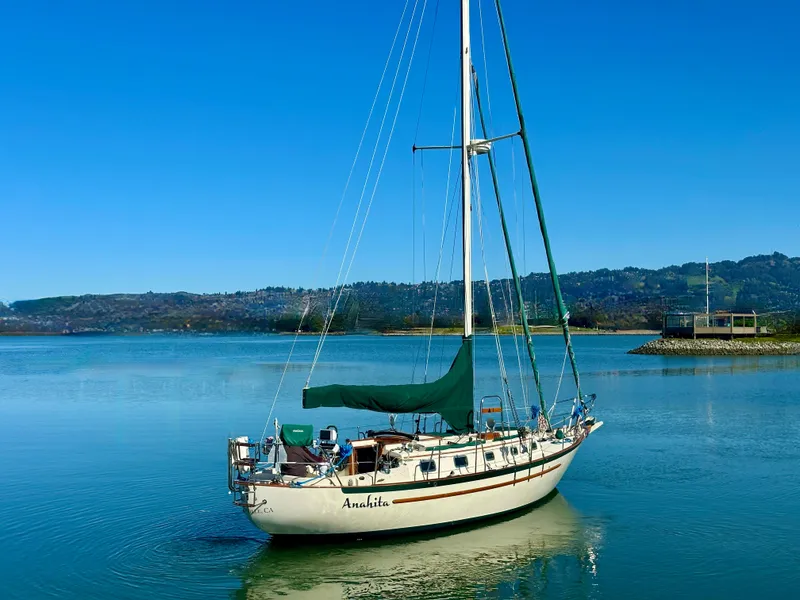 Slide: The Image of 1998 Pacific Seacraft Cutter sailboat on calm water with scenic background. - 2