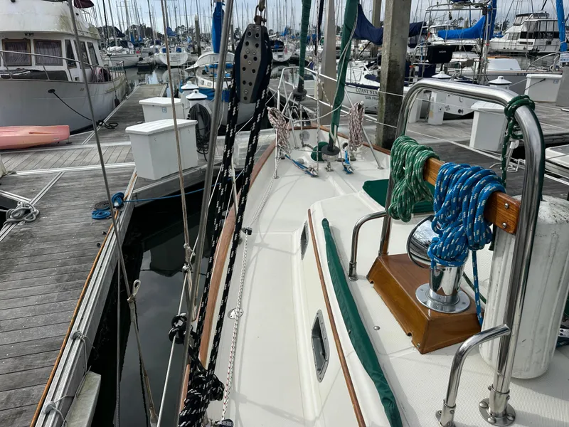 Slide: The Image of 1998 Pacific Seacraft Cutter sailboat docked at marina, featuring deck and rigging. - 24