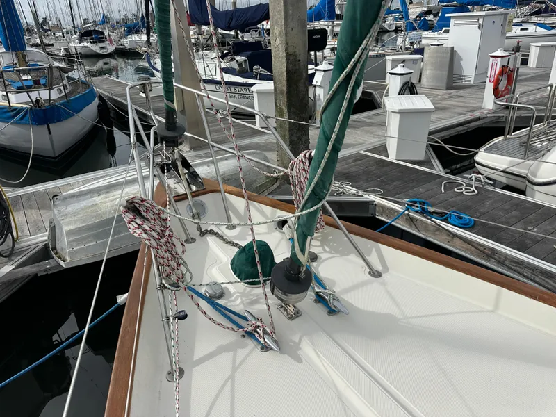 Slide: The Image of 1998 Pacific Seacraft Cutter sailboat docked at marina, featuring deck and rigging details. - 26