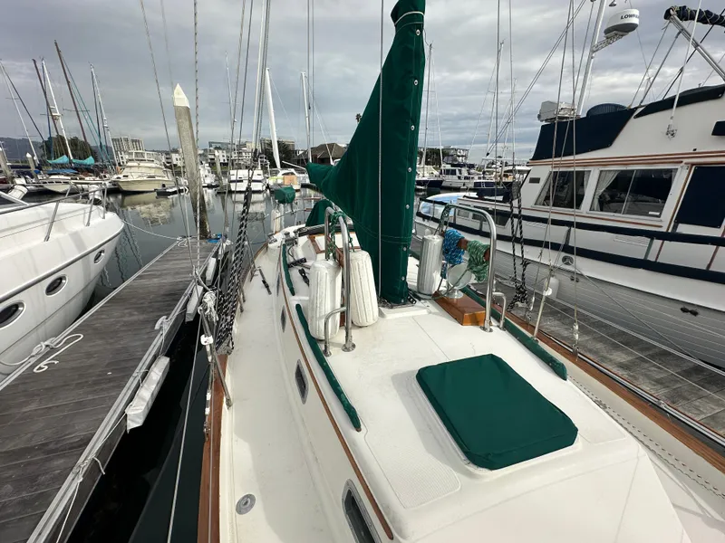 Slide: The Image of 1998 Pacific Seacraft Cutter sailboat docked in marina, overcast sky. - 27