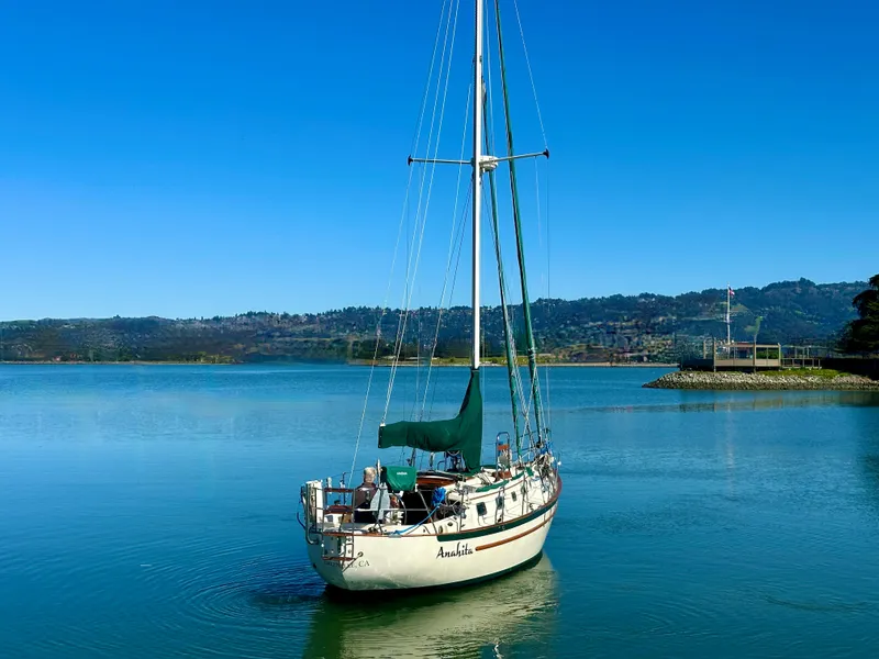 Slide: The Image of 1998 Pacific Seacraft Cutter sailboat on calm water under clear blue sky. - 3