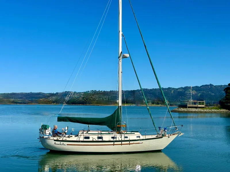 Slide: The Image of 1998 Pacific Seacraft Cutter sailboat on calm water under clear blue sky. - 4