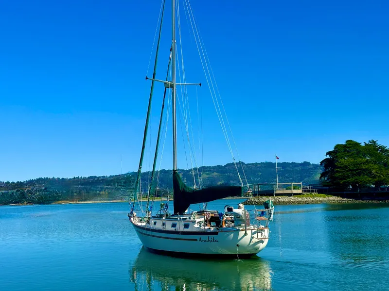 Slide: The Image of 1998 Pacific Seacraft Cutter sailboat on calm water under clear blue sky. - 5