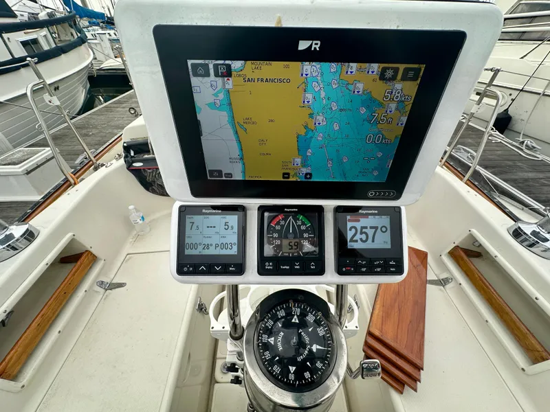 Slide: The Image of Navigation equipment on 1998 Pacific Seacraft Cutter sailboat, featuring GPS and compass. - 6