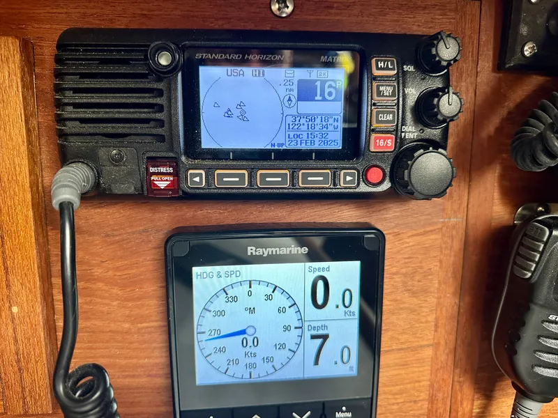 Slide: The Image of Navigation instruments on a 1998 Pacific Seacraft Cutter, featuring Standard Horizon and Raymarine displays. - 8