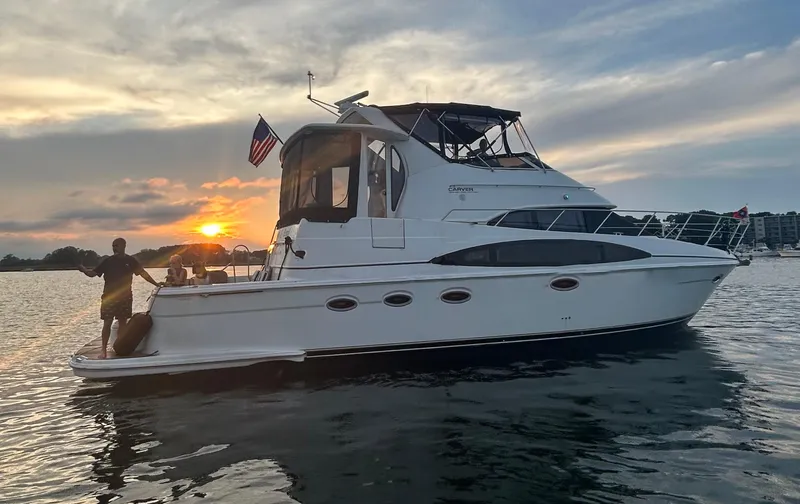 The Image of 2002 Carver 444 Cockpit Motor Yacht at sunset on calm waters. - 0