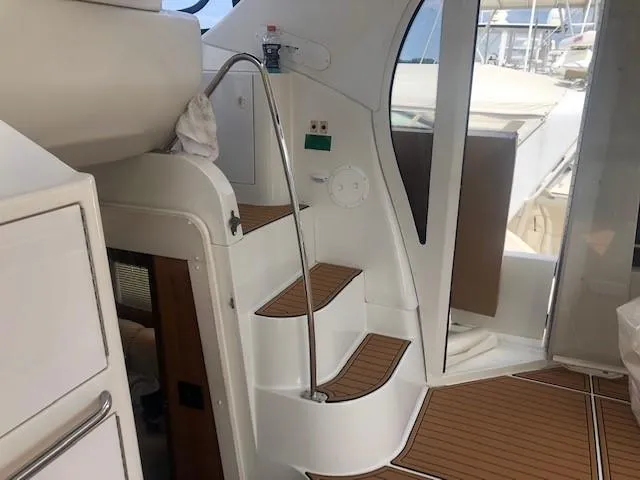 Slide: The Image of Interior of 2002 Carver 444 Cockpit Motor Yacht with wooden steps and sleek design. - 12