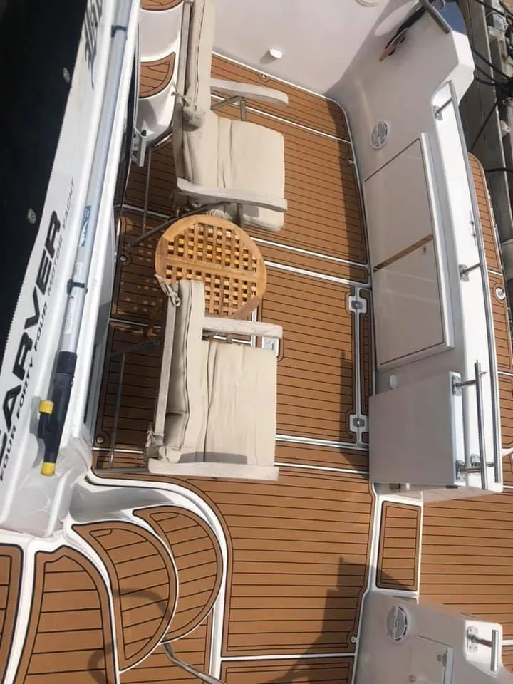 Slide: The Image of 2002 Carver 444 Cockpit Motor Yacht deck with chairs and table. - 13