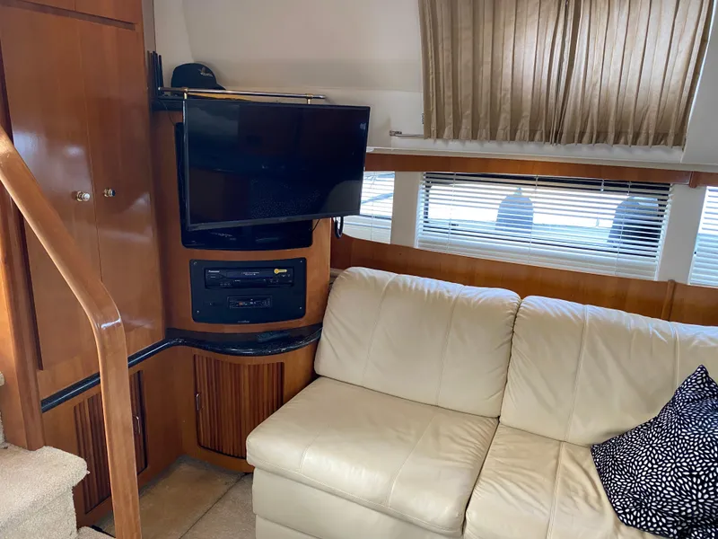 Slide: The Image of Interior of 2002 Carver 444 Cockpit Motor Yacht with TV and beige sofa. - 17